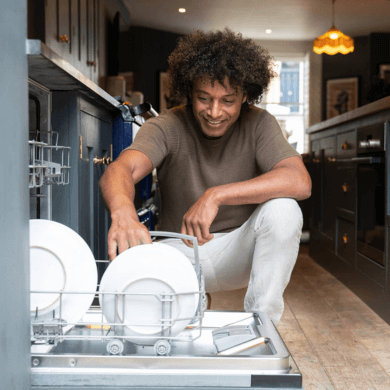 Man loading the dishwasher