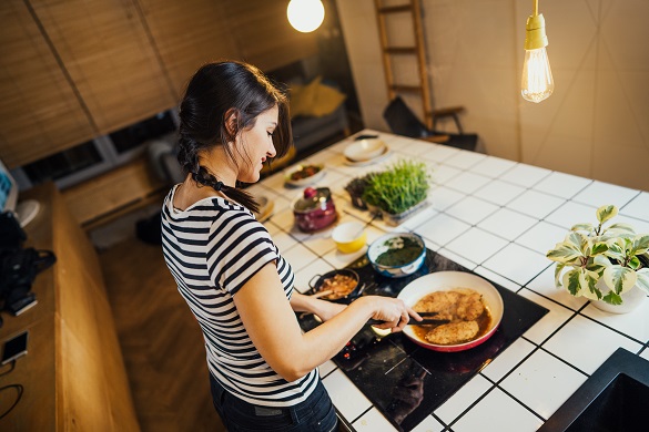 Woman cooking on an induction hob