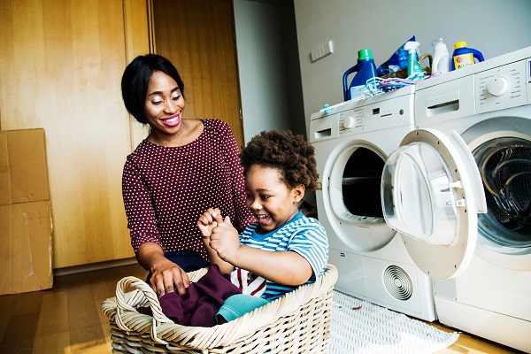 Mother and son doing laundry together 